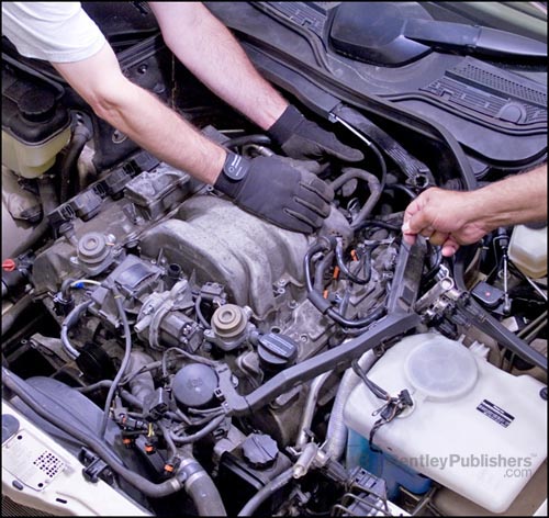 Bentley technical 
editors removing intake manifold on V6 (M 112) engine.(BentleyPublishers.com watermark not printed on actual product.)